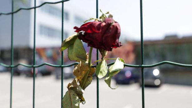 FILE PHOTO: Flowers and candles are seen in front of the fences of the school in Graz